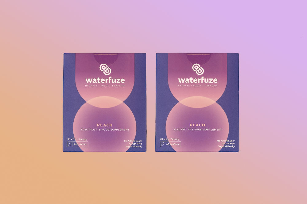 Two packages of waterfuze peach electrolyte food supplement on a gradient background